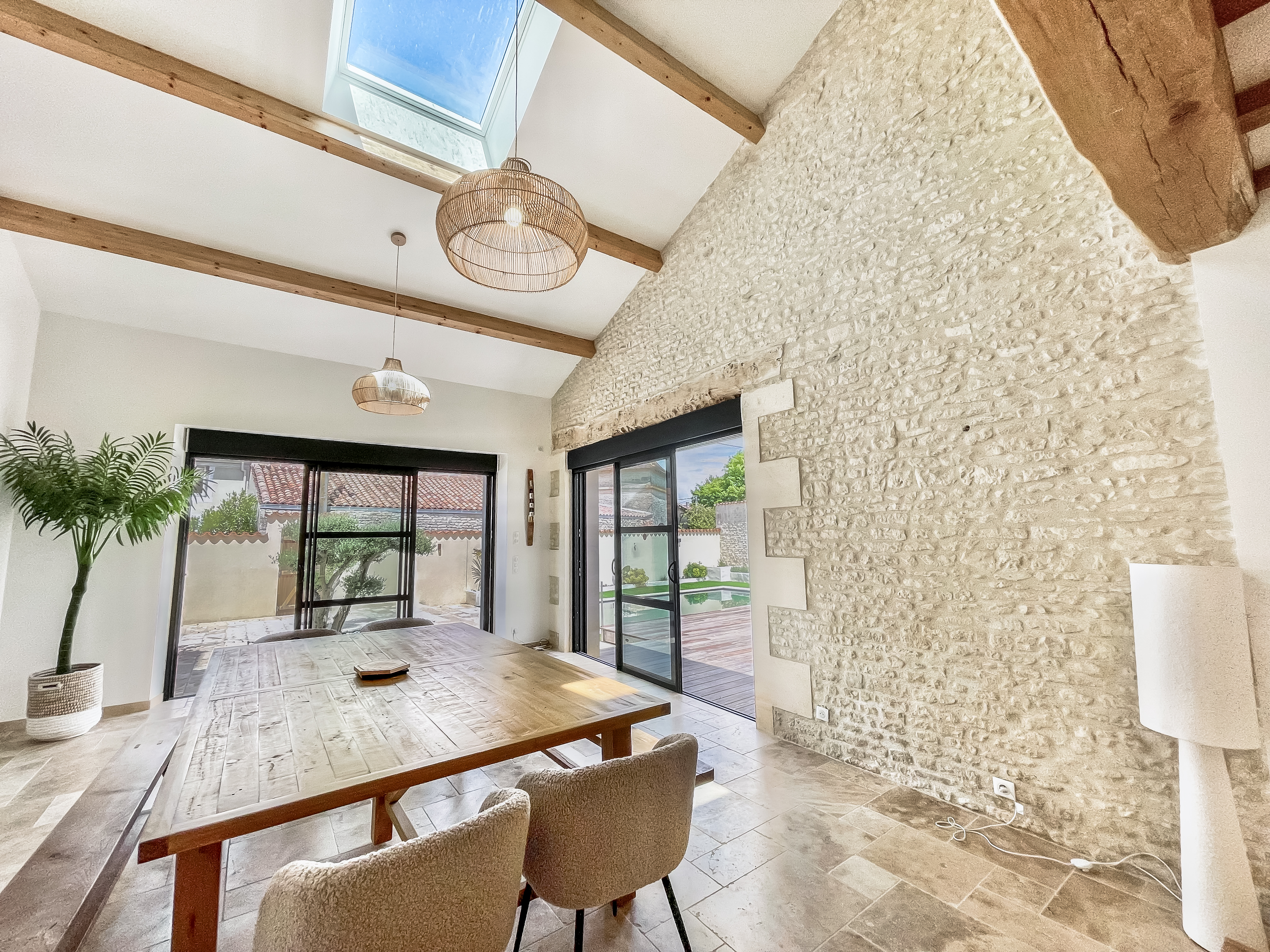 Double-height living area with stone walls